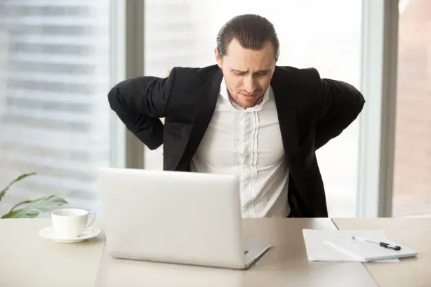 Businessman suffering from backache workplace